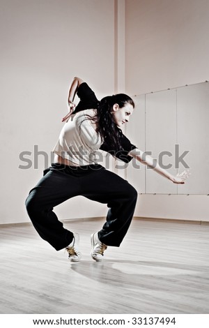 young pretty dancer in motion. photo in dance studio