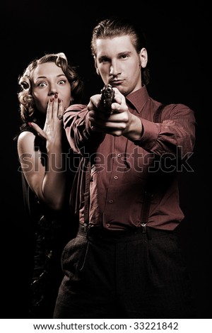 man with gun protecting his woman. retro portrait