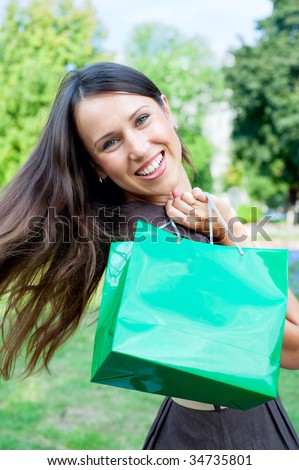 beautiful happy woman with green bag