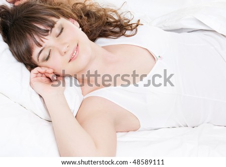 portrait of lively sleeping woman in the bed