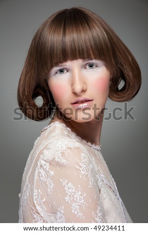fashion portrait of woman with haircut over grey background