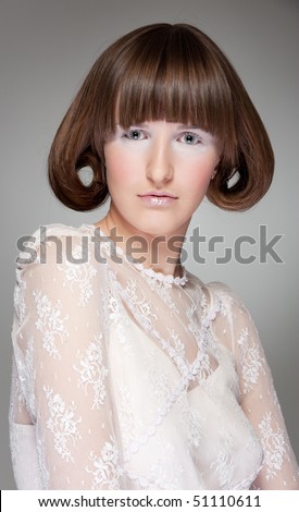 portrait of pretty woman with haircut over grey background