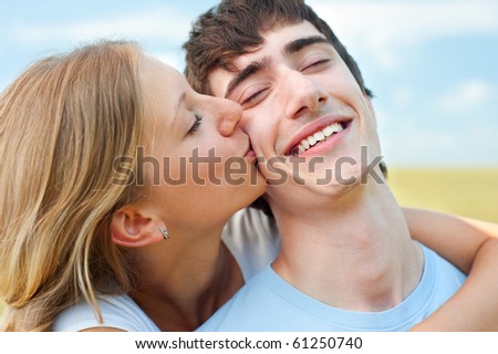 portrait of happy couple in love over blue sky