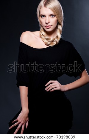 beautiful young blonde posing over dark background