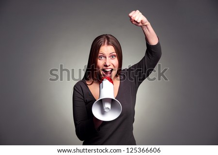 emotional young woman screaming in loudspeaker