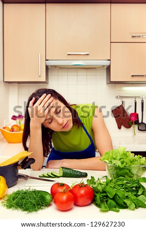 fatigued woman in the kitchen