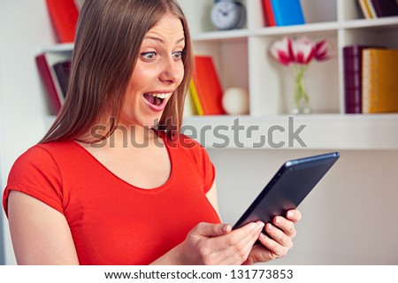 happy surprised woman looking at the tablet pc