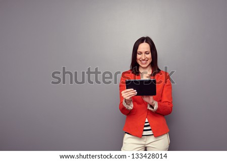 pretty woman using tablet computer over dark background