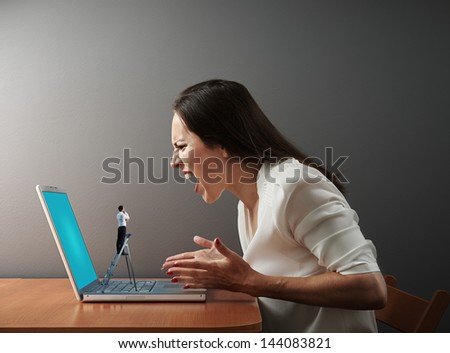little man from technical support looking at screaming woman with broken laptop