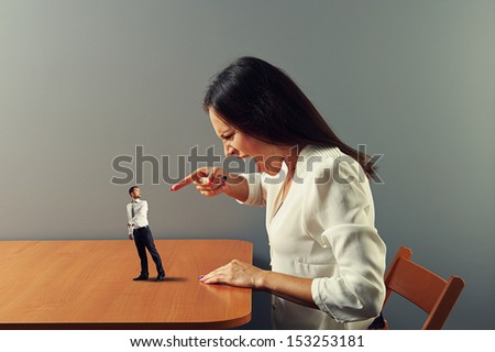 angry woman screaming at startled small man