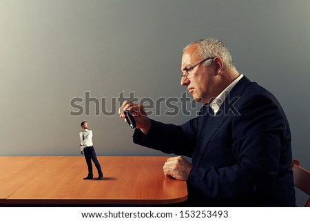 frightened worker under magnifying glass his boss