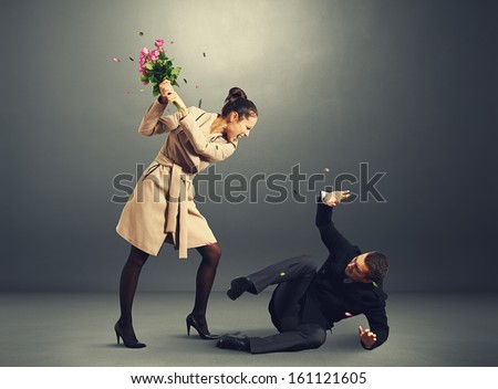young woman yelling at frightened man