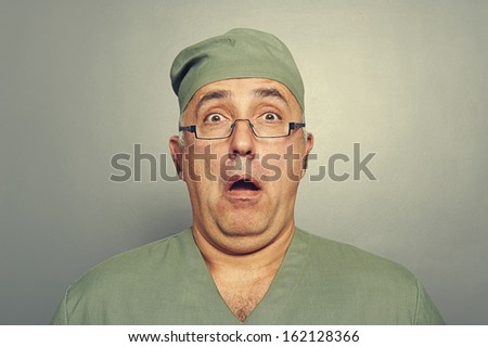 scared doctor in glasses looking at camera