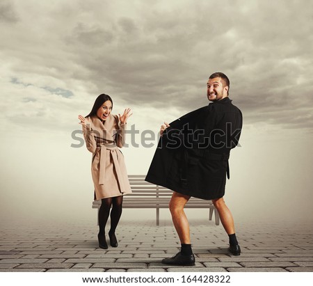 funny picture of laughing woman and crazy exhibitionist in coat