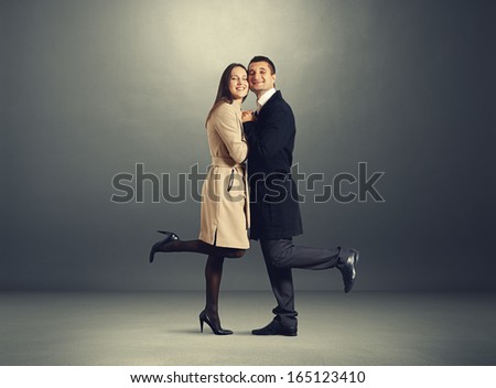 beautiful happy couple in love over dark background