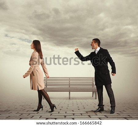 angry man shaking fist and shouting at outgoing woman