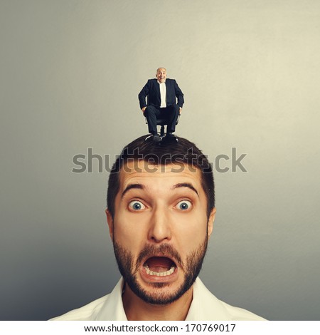 screaming scared man with laughing boss on the head