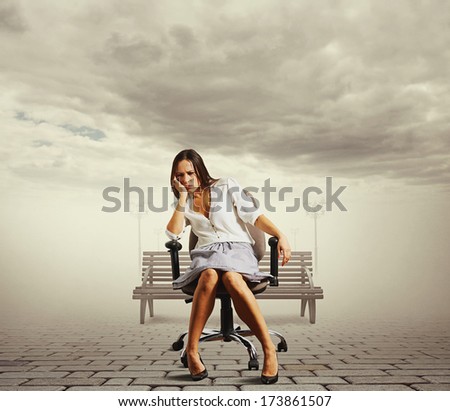 tired young woman sitting on the office chair at outdoor