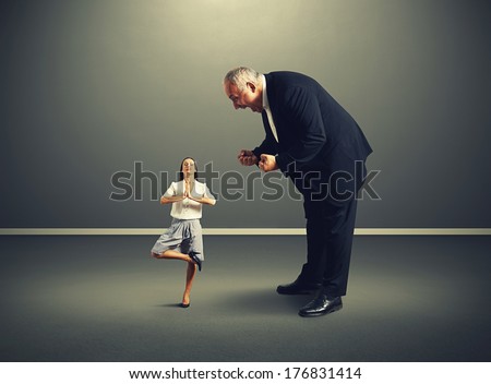 angry big boss screaming at small meditation businesswoman