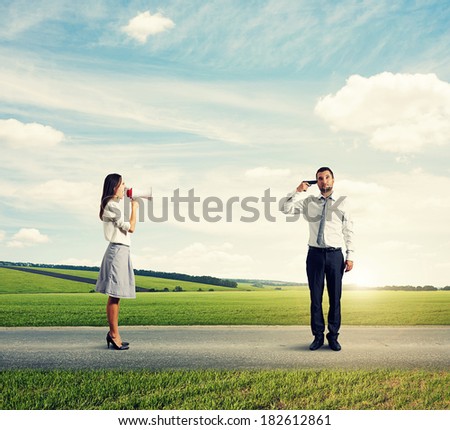 aggressive woman shouting at stressed man with gun on the road