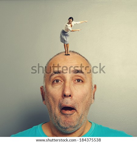 excited young woman pointing and looking at amazed man