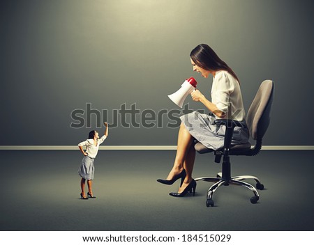 small woman screaming and showing fist to big angry woman over dark background