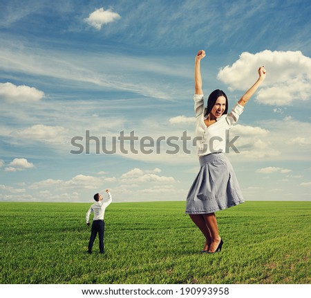 angry man screaming at happy businesswoman on the field