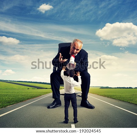 angry man screaming at frightened small man at outdoor