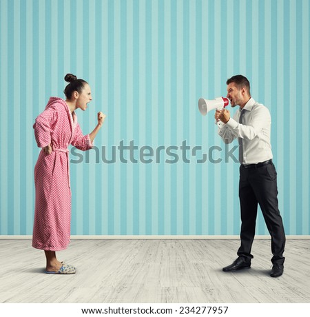 quarrel between dissatisfied wife and angry husband with megaphone