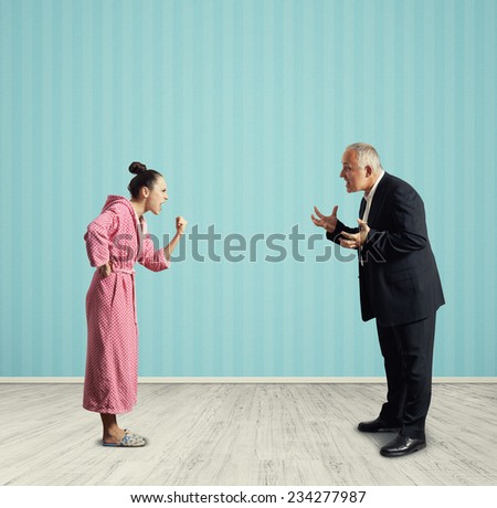 angry housewife screaming at senior man in formal wear in the room