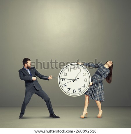 emotional couple stretching out the clock and screaming over dark background