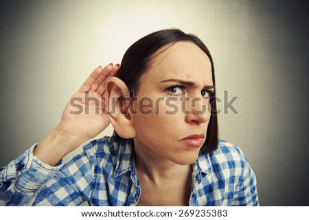 comic picture of serious woman with one big ear listening attentively and looking at camera. photo on dark background