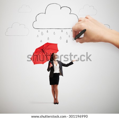 big hand drawing clouds with drops, smiley businesswoman with red umbrella standing under rain and looking up over light grey background