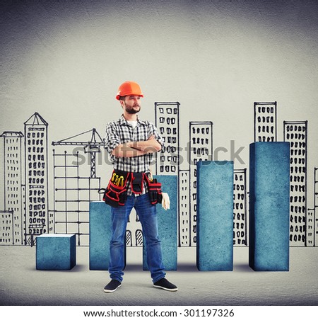 serious builder with folded hands over concrete diagram and drawing cityscape