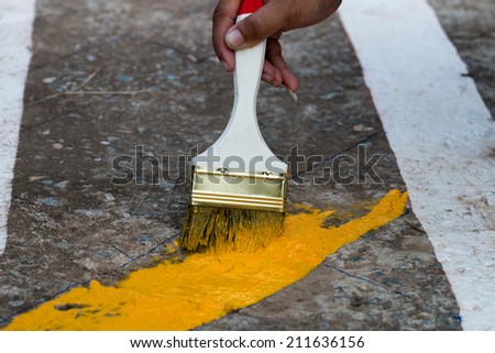painting the the yellow line on the concrete road