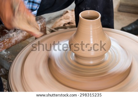 Potter hands making in clay on pottery wheel. Potter makes a pottery on the pottery wheel clay pot.