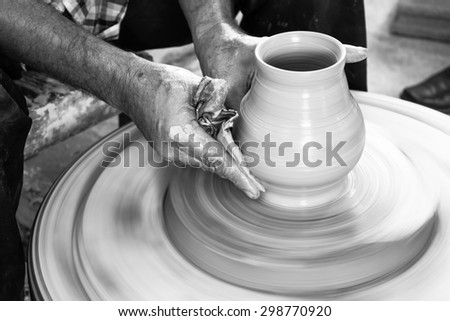 Potter hands making in clay on pottery wheel. Potter makes a pottery on the pottery wheel clay pot.