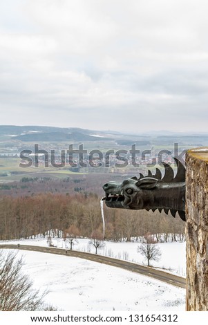 Frozen Medieval Dragon Statue with Icicle on the Giechburg Castle Ruin in Bavaria, Germany