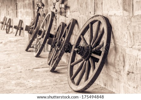 Wheel Of Time. Vintage Black And White Picture Of Old Wooden Wheels On A Castle In Bavaria, Germany / Europe . Still Life Picture. Stone Walls.