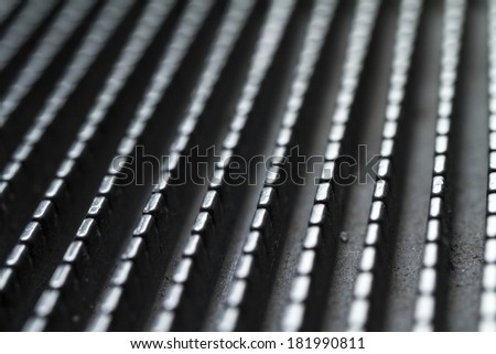 Macro Picture of an Escalator with intentional blurredness. Industrial metallic shining background