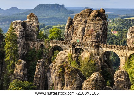 Bastion Bridge in the Saxonian Swiss in Germany, shot on a warm summer morning after sunrise. Landmark of Saxonia. Sandstone Rock Formations. Bridge leading to a former medieval castle near Dresden