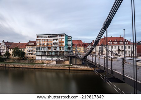 BAMBERG, GERMANY - SEPTEMBER 26 2014: Evening at a Bridge in the bavarian World Culture Heritage City of Bamberg in Oberfranken, Germany. Historical Ducke Building