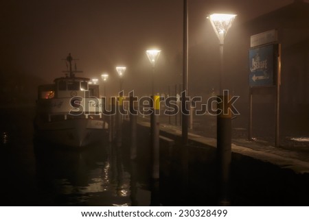 CONSTANCE, GERMANY - NOVEMBER 02 2014: Harbor at Lake Constance in Autumn. Lovely atmosphere in the german city of Constance in Baden Wurttemberg. Foggy Night Atmosphere