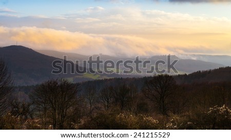 Dramatic Winter Landscape. German Winter Countryside with hills and barren trees. Castle on a hill. Lovely fairytale landscape