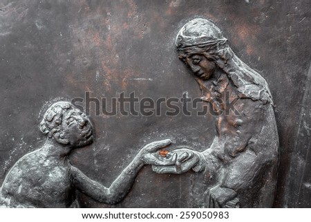 WUERZBURG, GERMANY - MARCH 08 2015: Charity Picture from a Door the Catholic Christian Cathedral of Wuerzburg in Bavaria, Germany