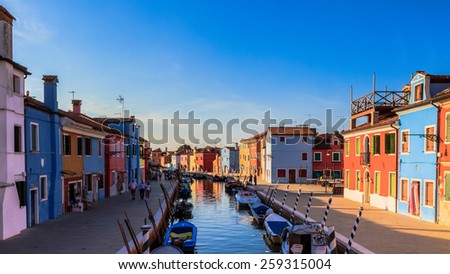 BURANO, ITALY - SEPTEMBER 09 2013: Colorful Houses of Burano. Tourism Island in the Lagoon of Venice. Evening Atmosphere on a warm late summer day