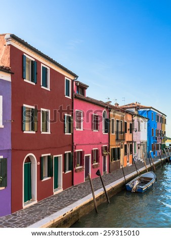 BURANO, ITALY - SEPTEMBER 09 2013: Colorful Houses of Burano. Tourism Island in the Lagoon of Venice. Evening Atmosphere on a warm late summer day