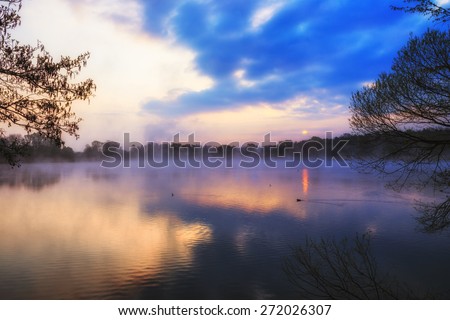 Lake Sunrise. Dawn at a fish lake in Upper Franconia, Germany. Lovely Blue and Purple Colors in spring. HDR picture with calm atmosphere