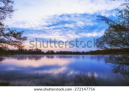 Lake Sunrise. Dawn at a fish lake in Upper Franconia, Germany. Lovely Blue and Purple Colors in spring. HDR picture with calm atmosphere
