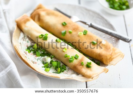 Crepes stuffed with Cream Cheese and Salmon with Sour Cream Sauce and chopped green onions